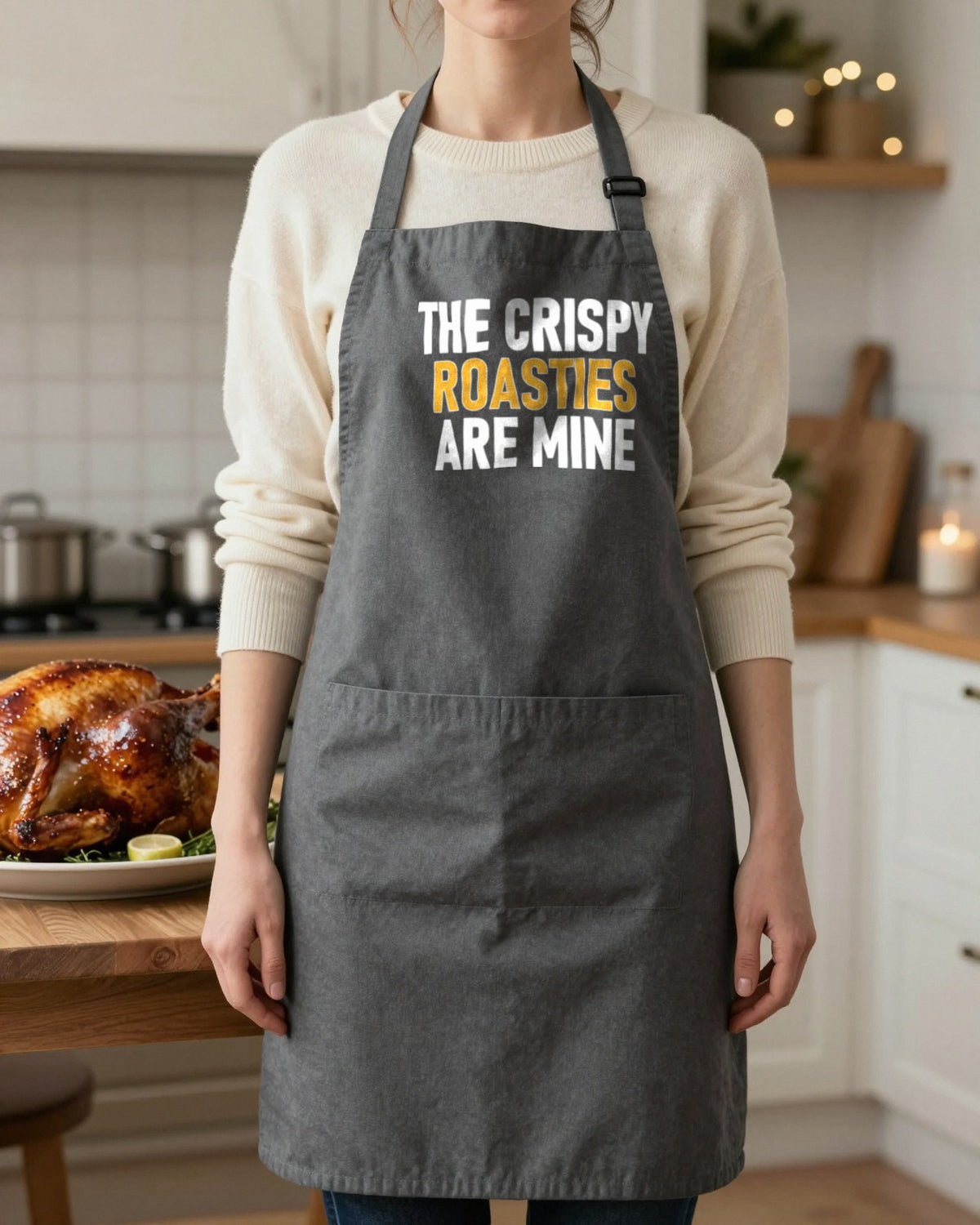 Crispy Roasties Are Mine Christmas apron in Dark Grey, worn, our photo