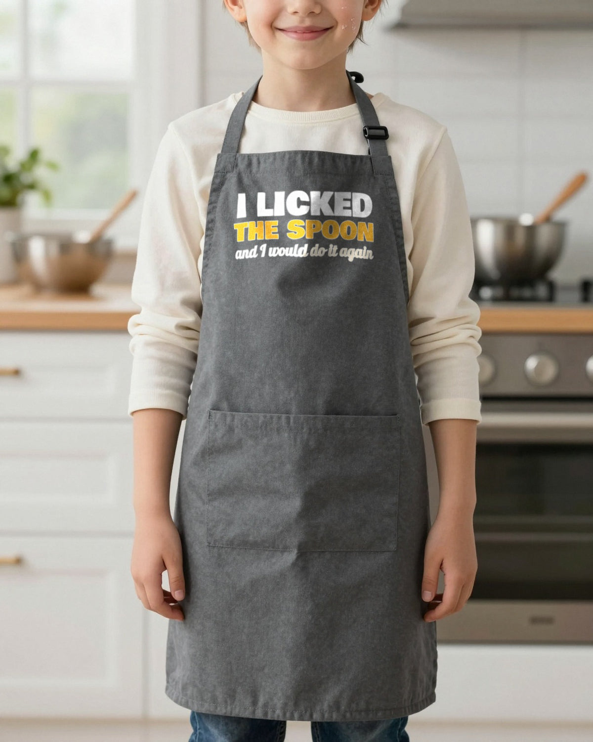 I Licked The Spoon kids apron in Dark Grey, worn, our photo