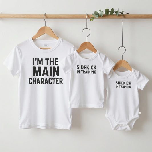 Main Character & Sidekick grown-up tee, kids tee and baby grow on hangers