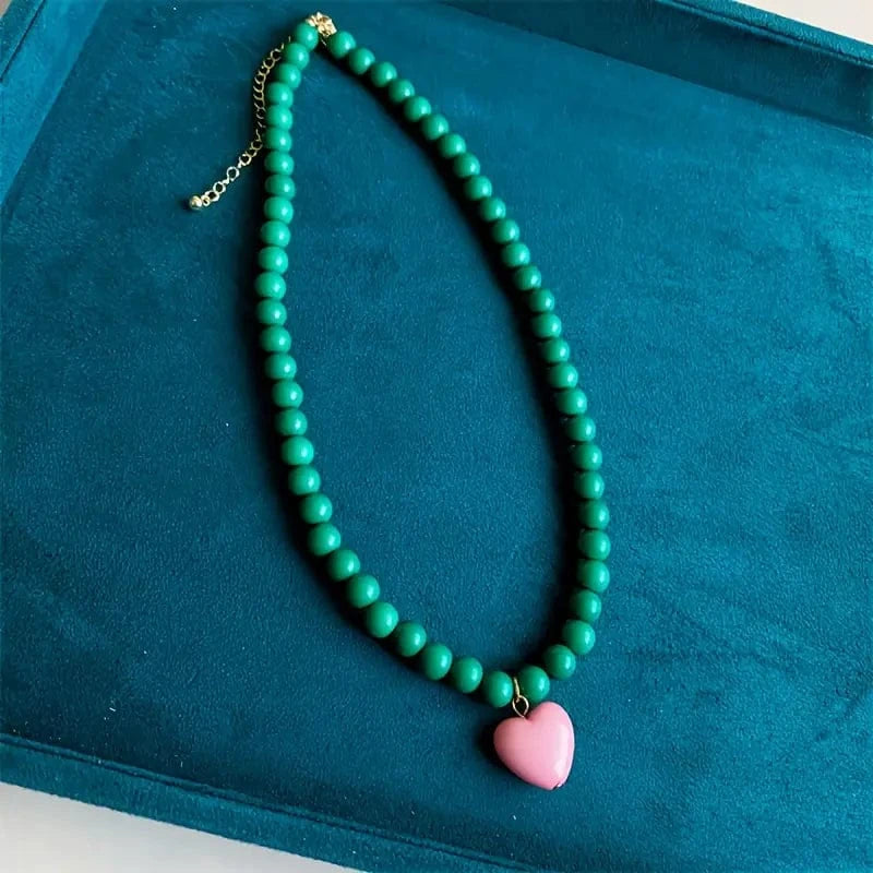 green beaded heart necklace with pink resin pendant colourful festival jewellery