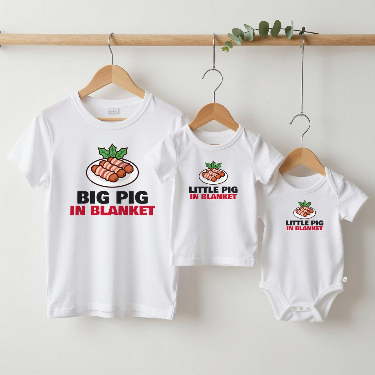 Big Pig & Little Pig in Blanket Christmas matching set grown-up tee, kids tee and baby grow on hangers