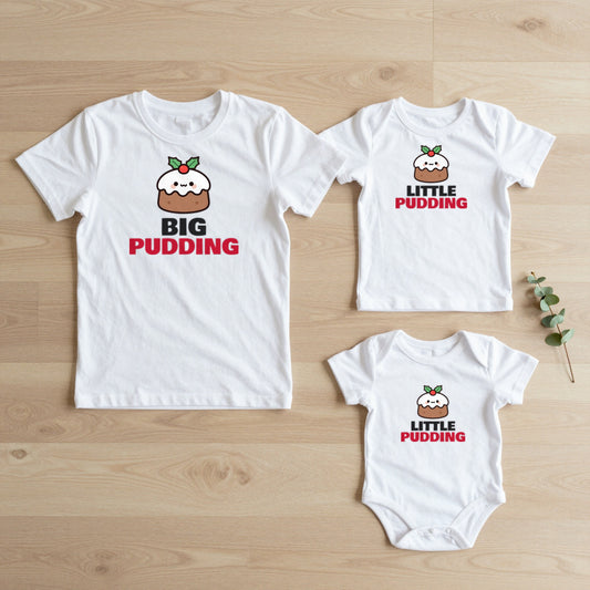Big Pudding & Little Pudding Christmas matching set flat lay on oak floor: grown-up tee, kids tee and baby grow