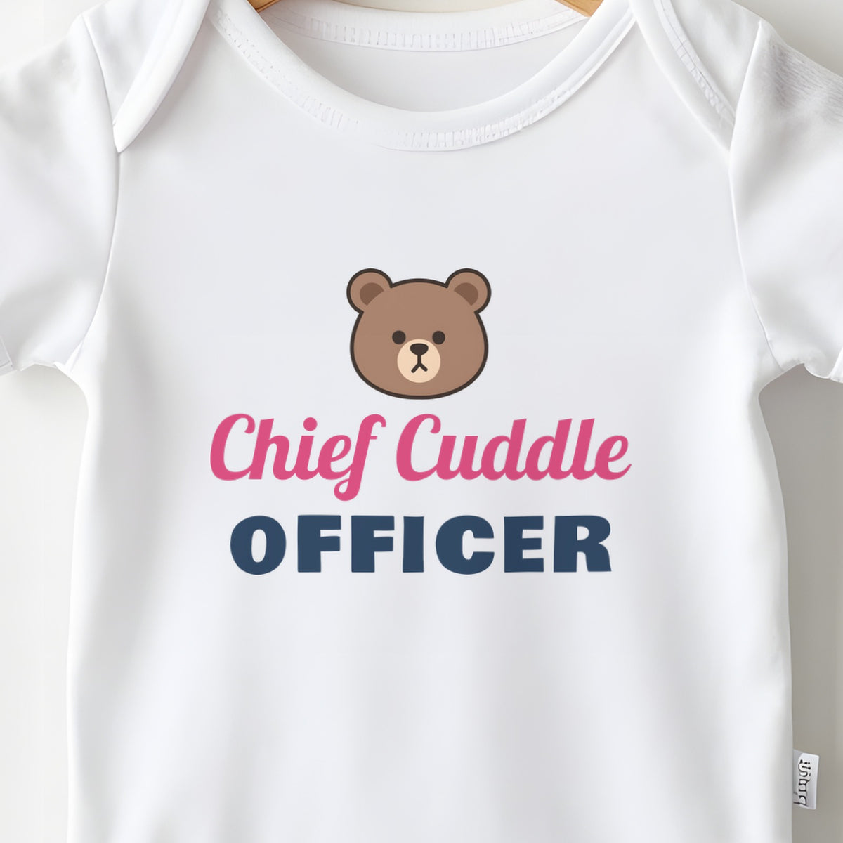 Chief Cuddle Officer baby grow print close-up