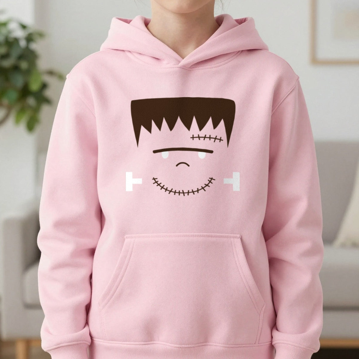 Cute Frankenstein Face Halloween Kids Hoodie in Light Pink, worn, our photo