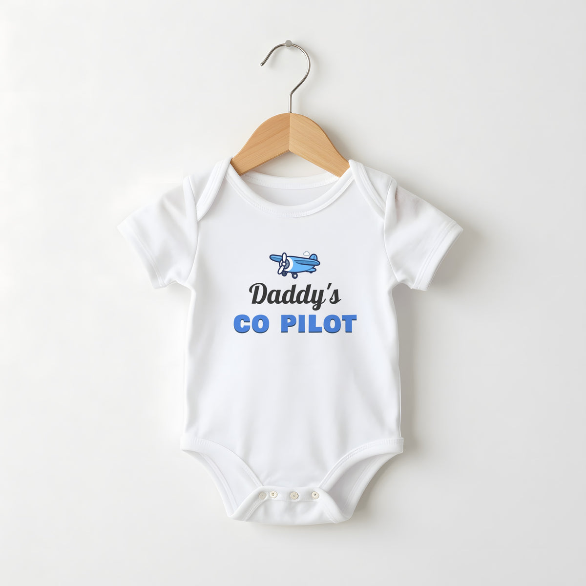 Daddy's Co-Pilot white baby grow on a hanger