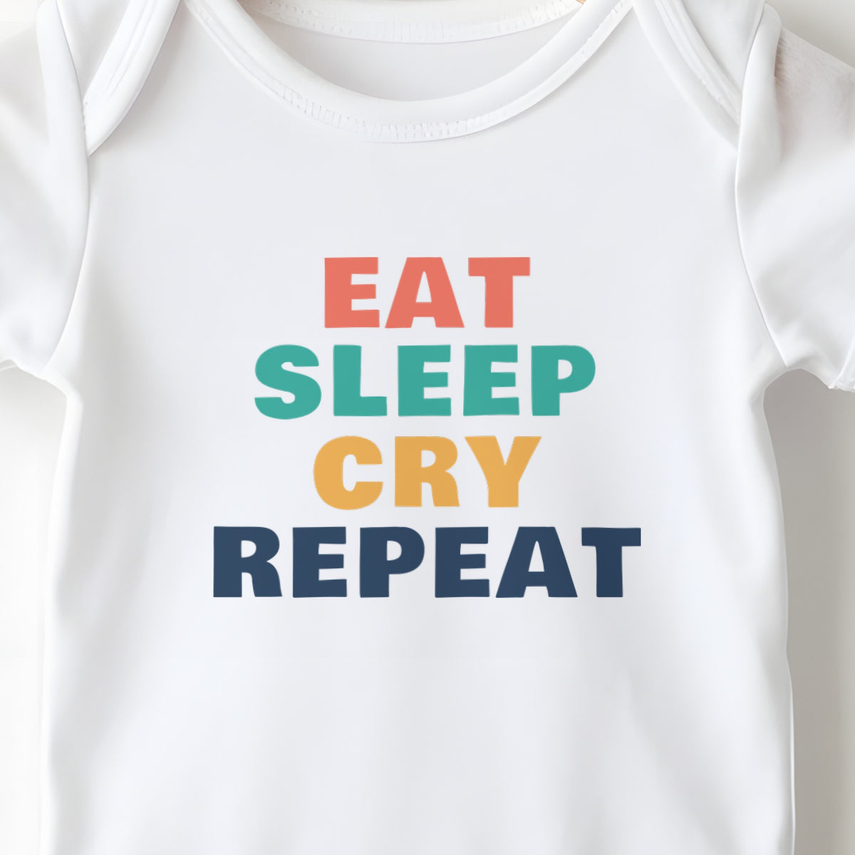 Eat Sleep Cry Repeat baby grow print close-up