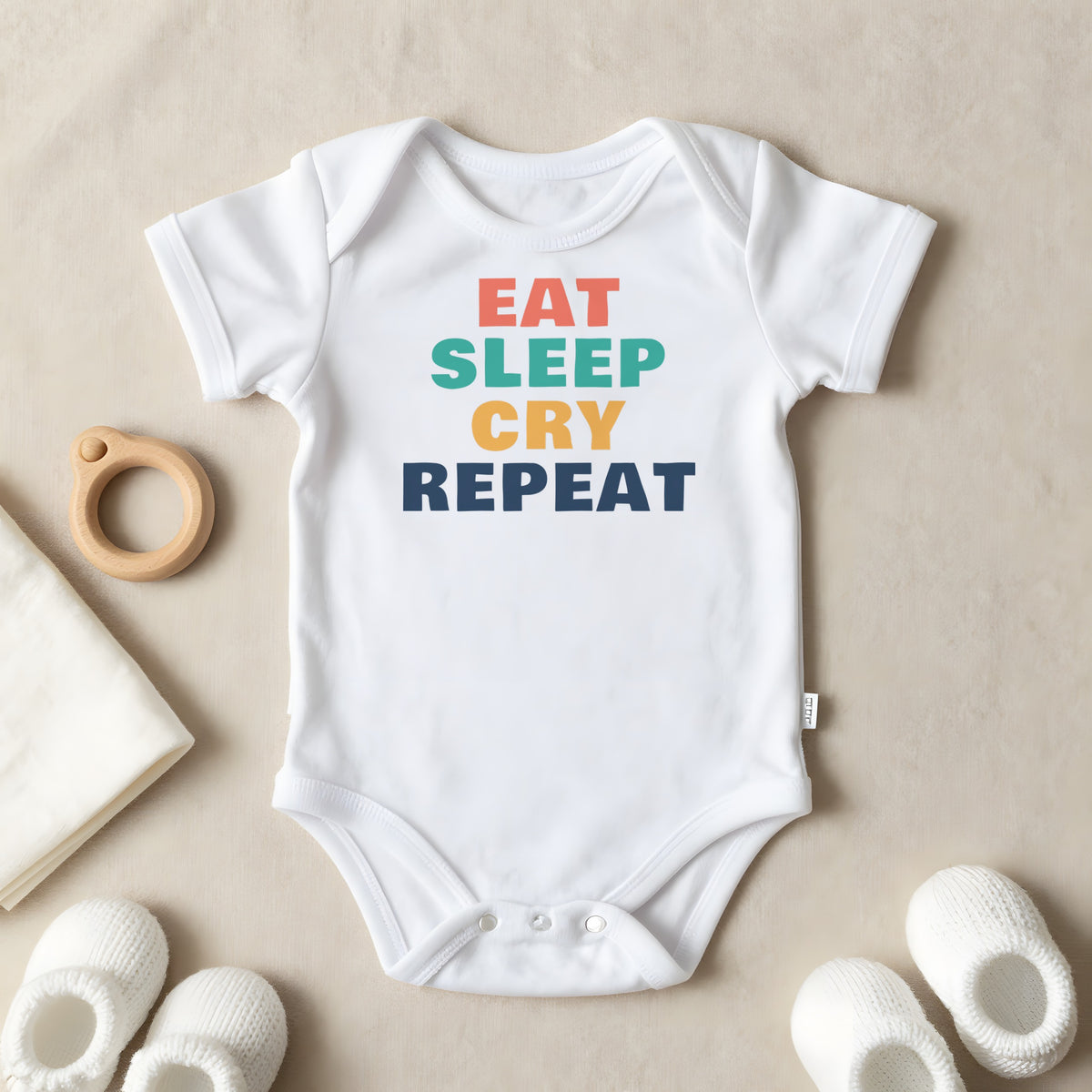 Eat Sleep Cry Repeat baby grow laid flat