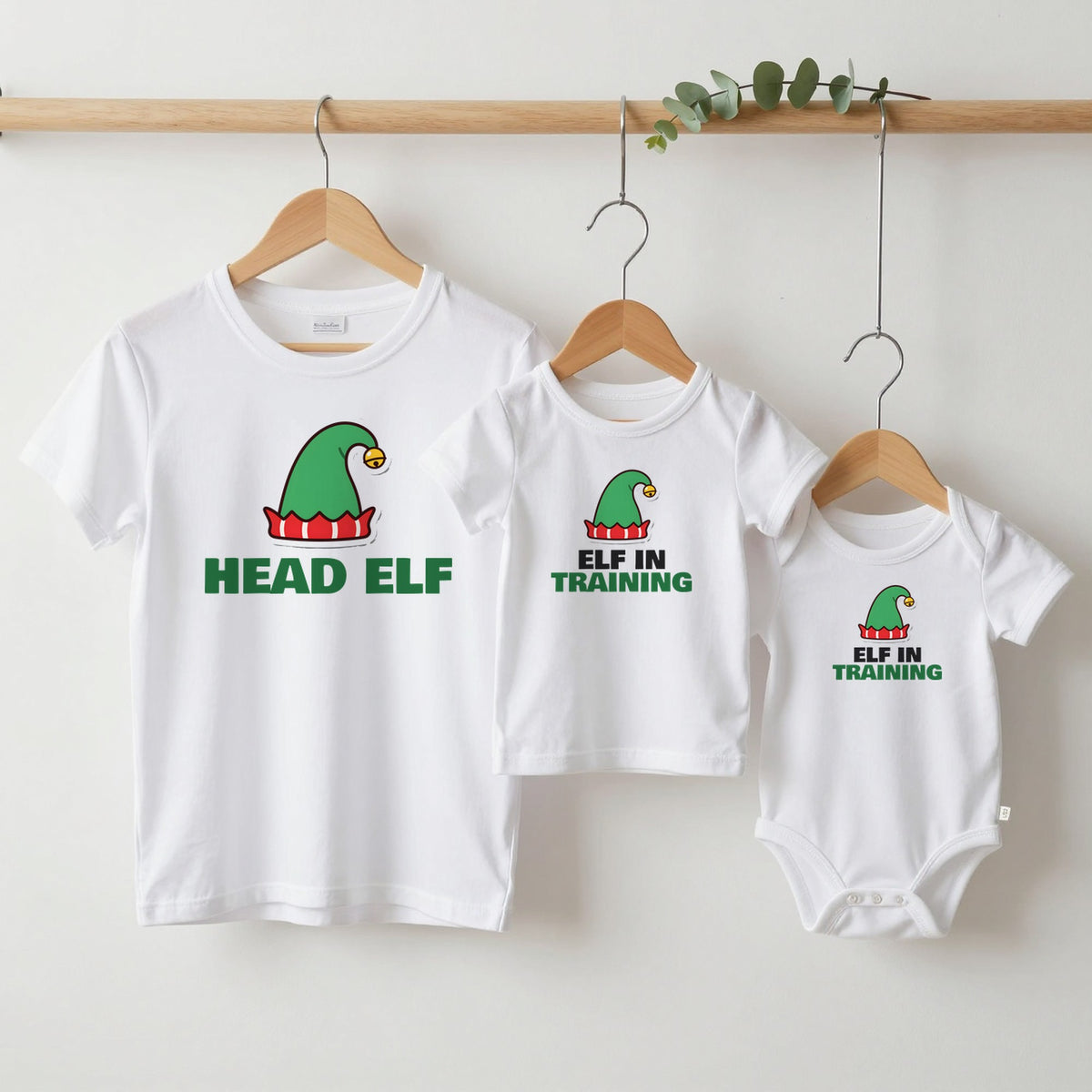 Head Elf & Elf in Training Christmas matching set grown-up tee, kids tee and baby grow on hangers