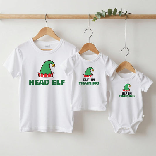 Head Elf & Elf in Training Christmas matching set grown-up tee, kids tee and baby grow on hangers