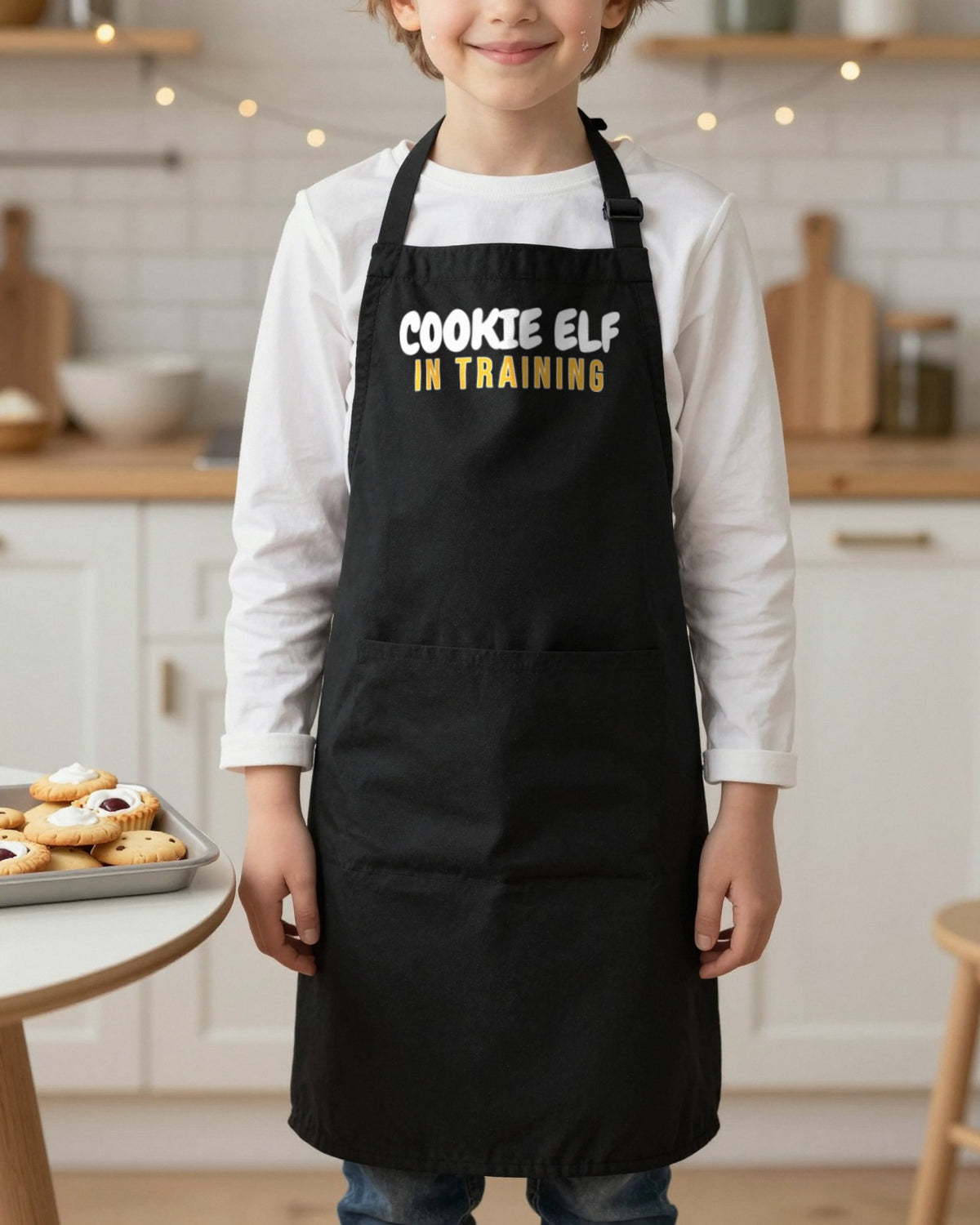 Cookie Elf In Training kids apron in Black, worn, our photo