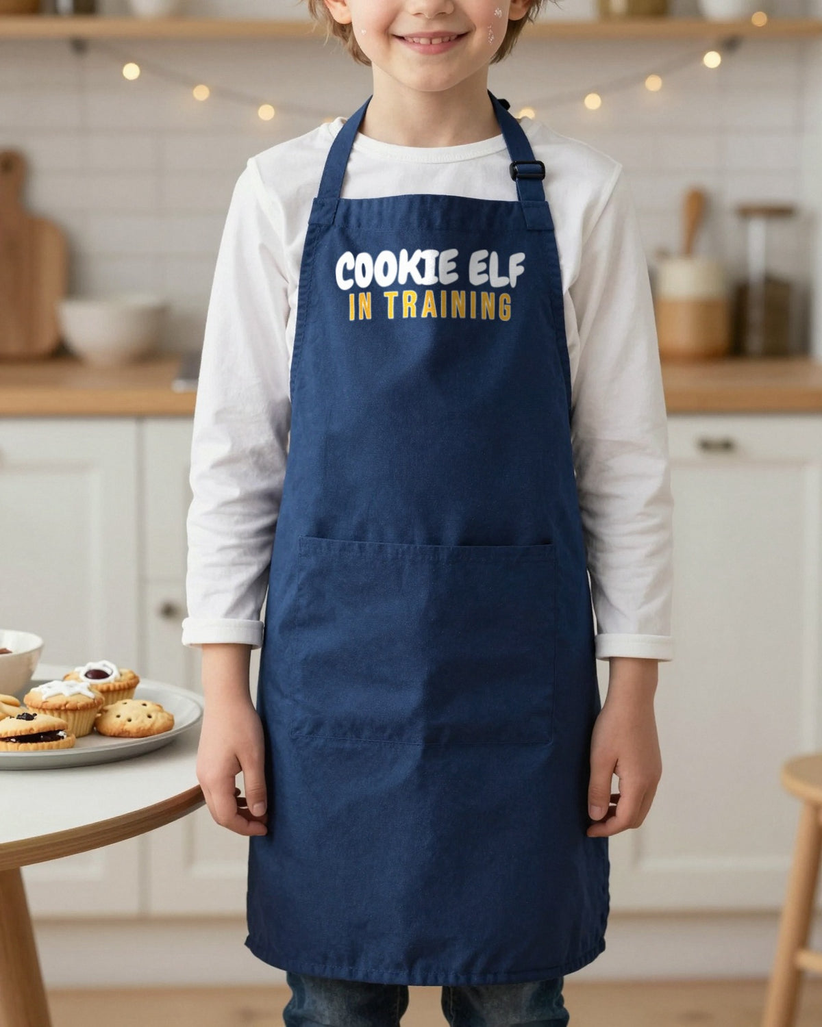 Cookie Elf In Training kids apron in Navy, worn, our photo