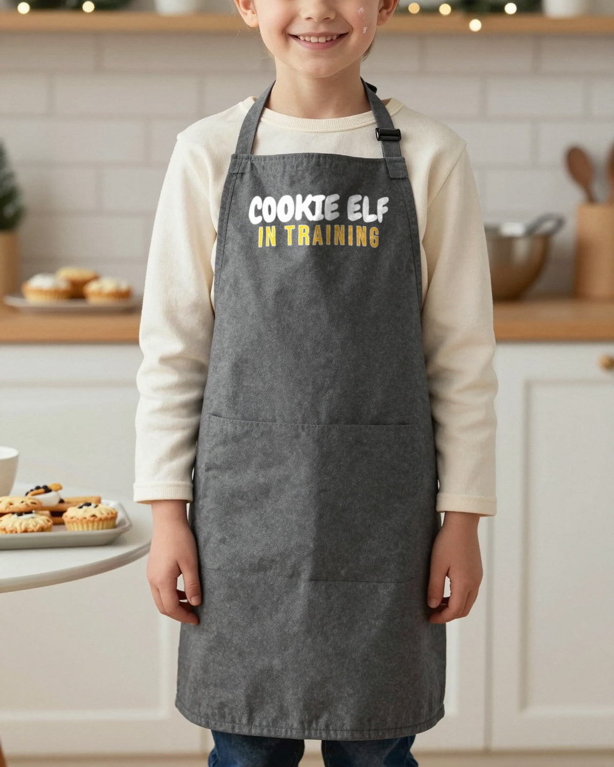 Cookie Elf In Training kids apron in Dark Grey, worn, our photo