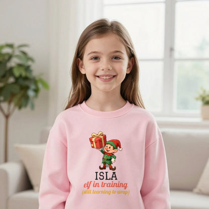 Kids Personalised Elf In Training Christmas T-Shirt & Sweatshirt Sweatshirt in Light Pink, worn, our photo
