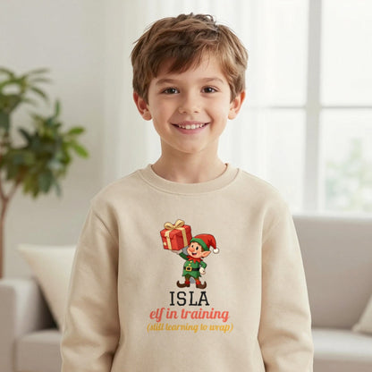 Kids Personalised Elf In Training Christmas T-Shirt & Sweatshirt Sweatshirt in Sand, worn, our photo