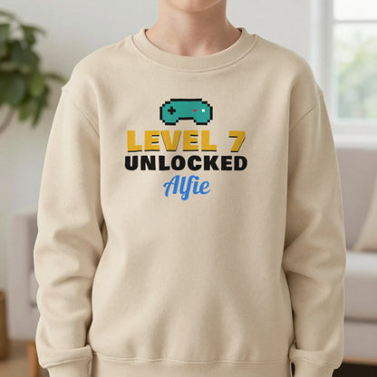 Kids Personalised Level Unlocked Birthday T-Shirt & Sweatshirt Sweatshirt in Sand, worn, our photo