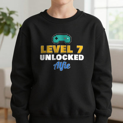 Kids Personalised Level Unlocked Birthday T-Shirt & Sweatshirt Sweatshirt in Black, worn, our photo