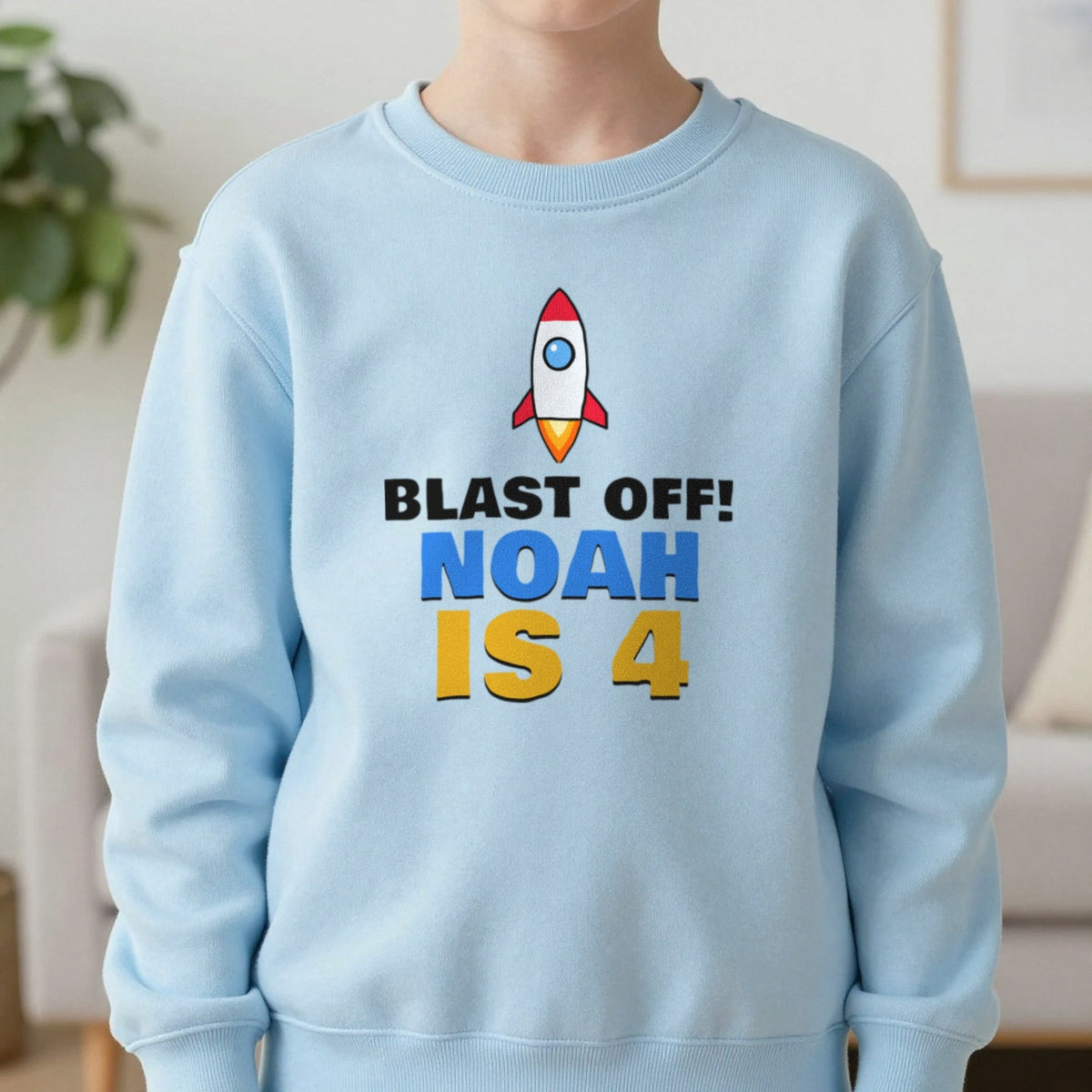 Kids Personalised Space Rocket Birthday T-Shirt Sweatshirt in Light Blue, worn, our photo