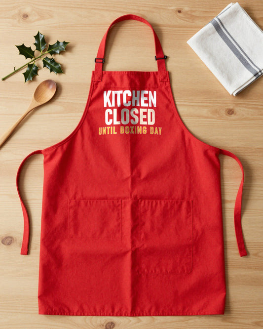 Kitchen Closed Until Boxing Day Christmas apron laid flat