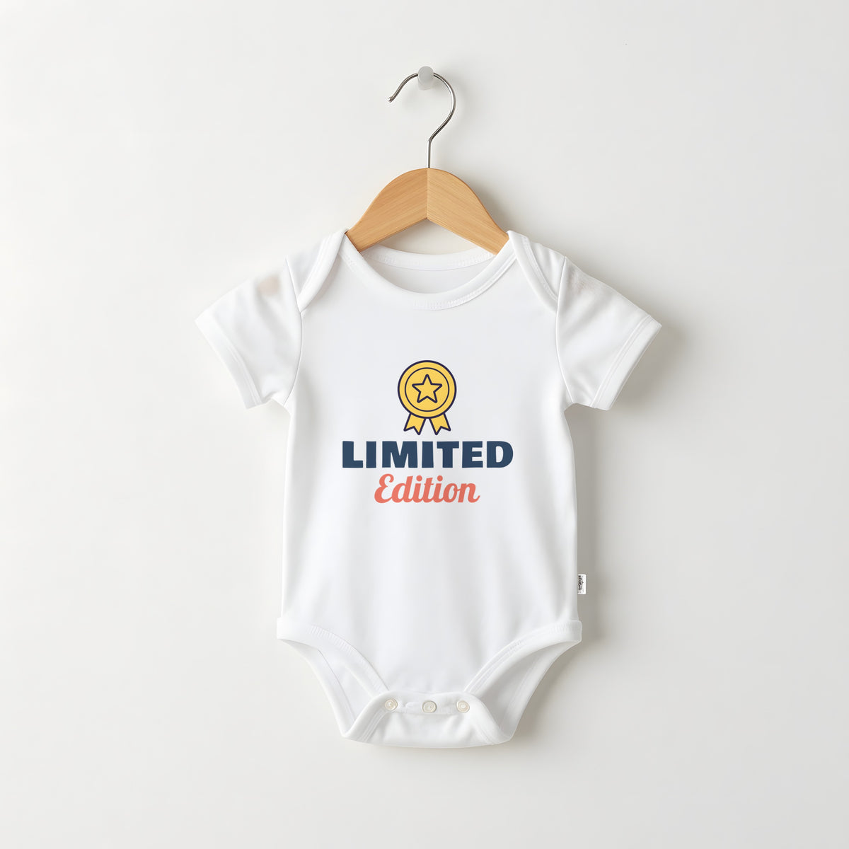 Limited Edition white baby grow on a hanger