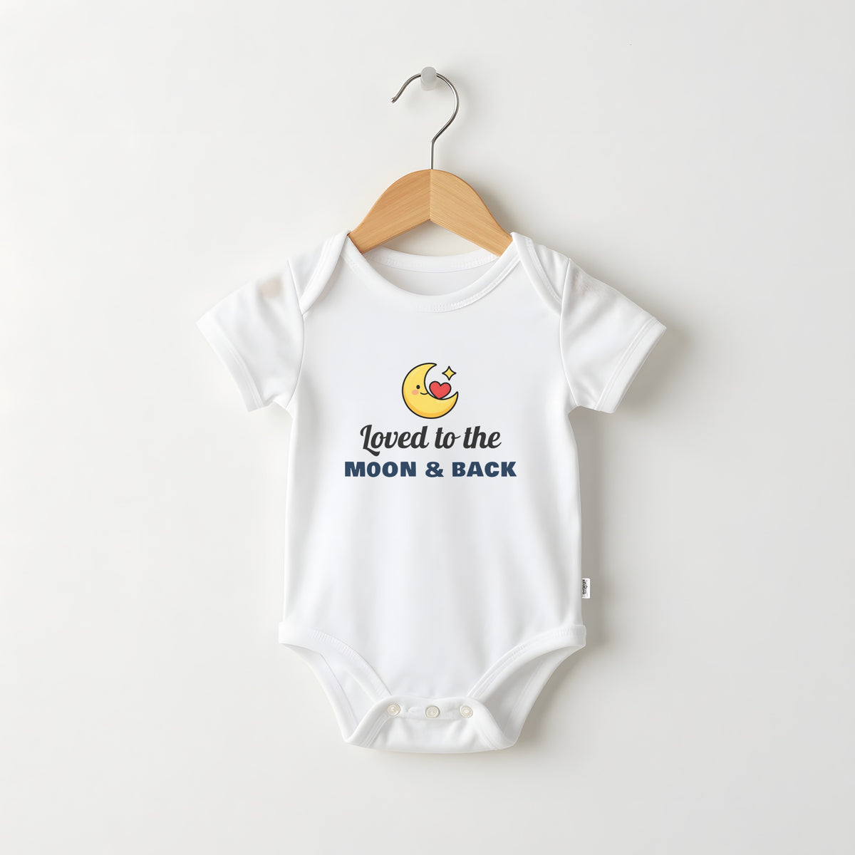 Loved To The Moon And Back white baby grow on a hanger