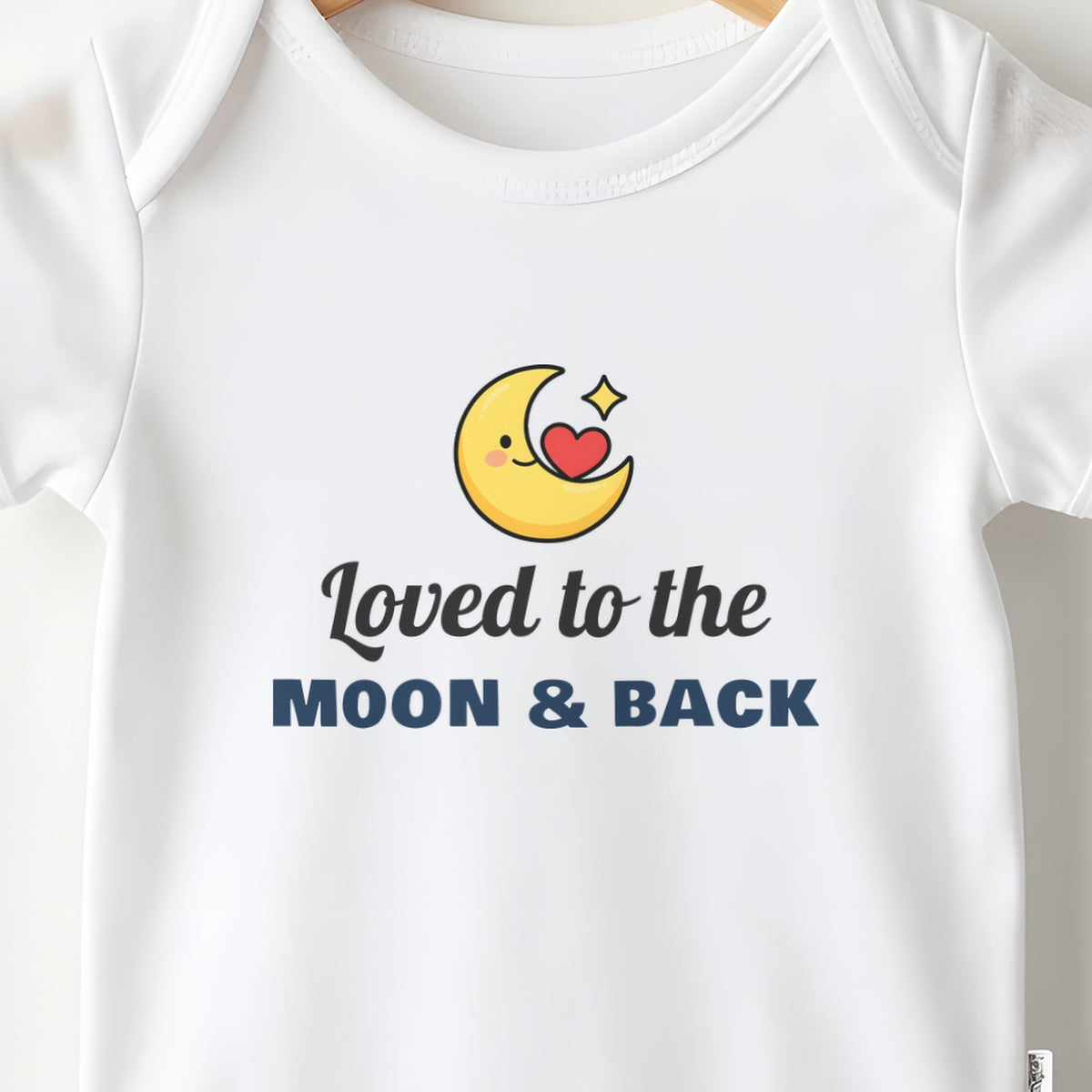 Loved To The Moon And Back baby grow print close-up