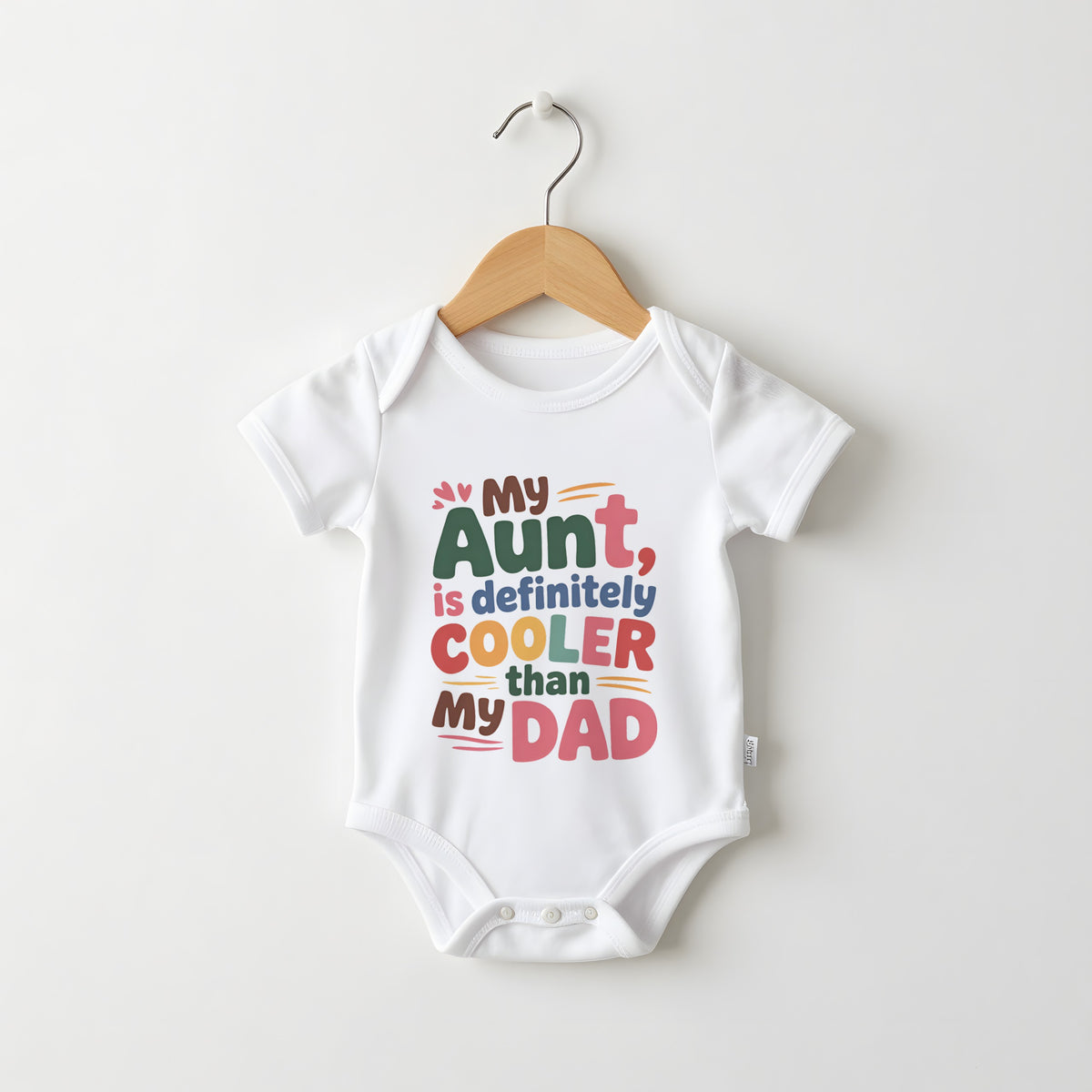 My Aunt Is Cooler Than My Dad white baby grow on a hanger