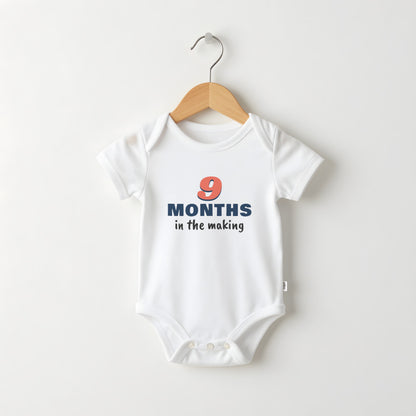 9 Months In The Making white baby grow on a hanger