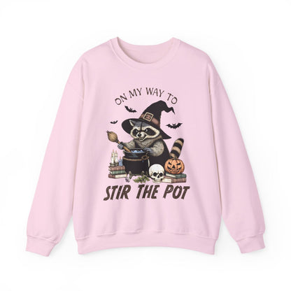 white sweatshirt with witchy raccoon cauldron candles and books spooky design