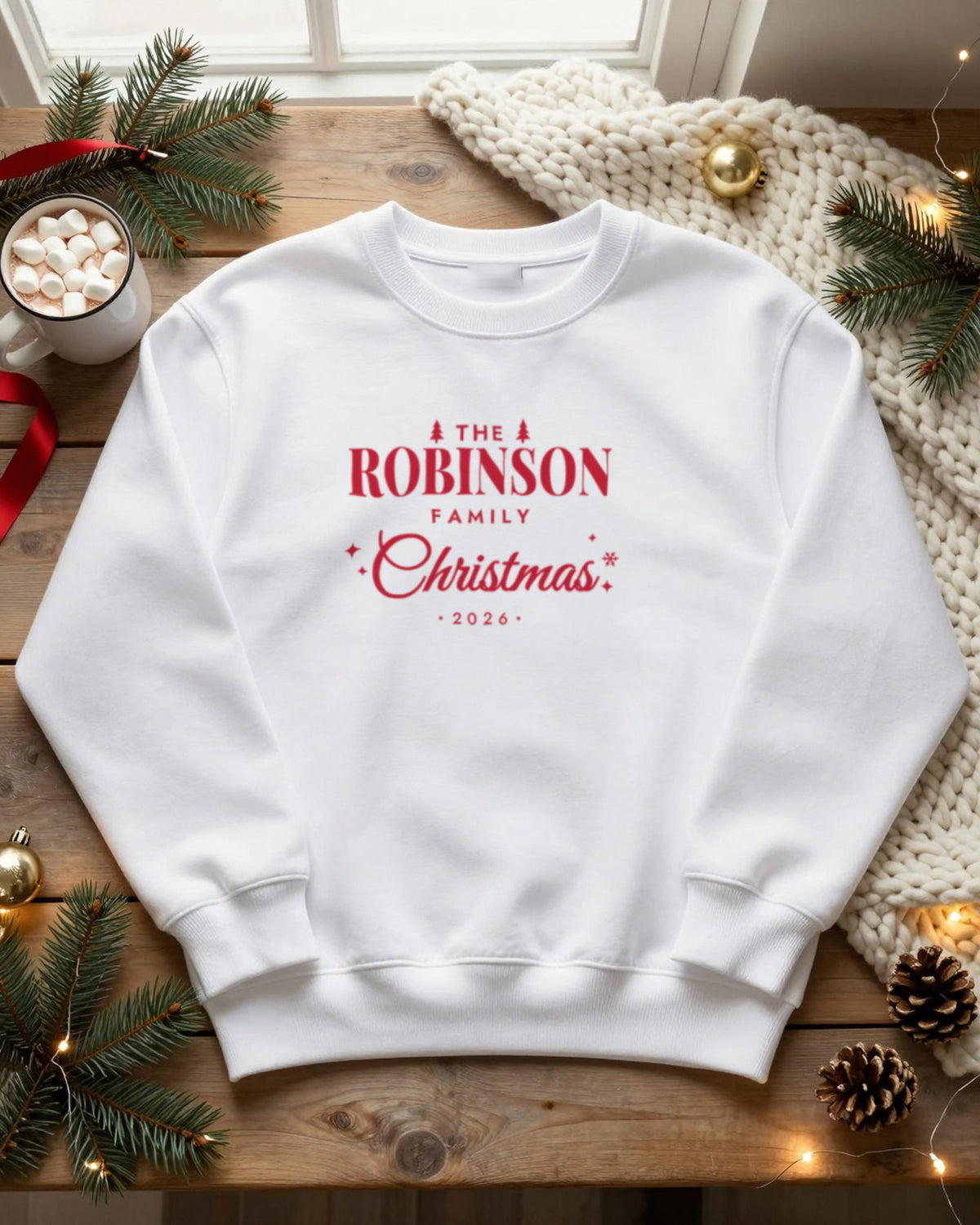 White personalised family Christmas jumper flat lay with red print