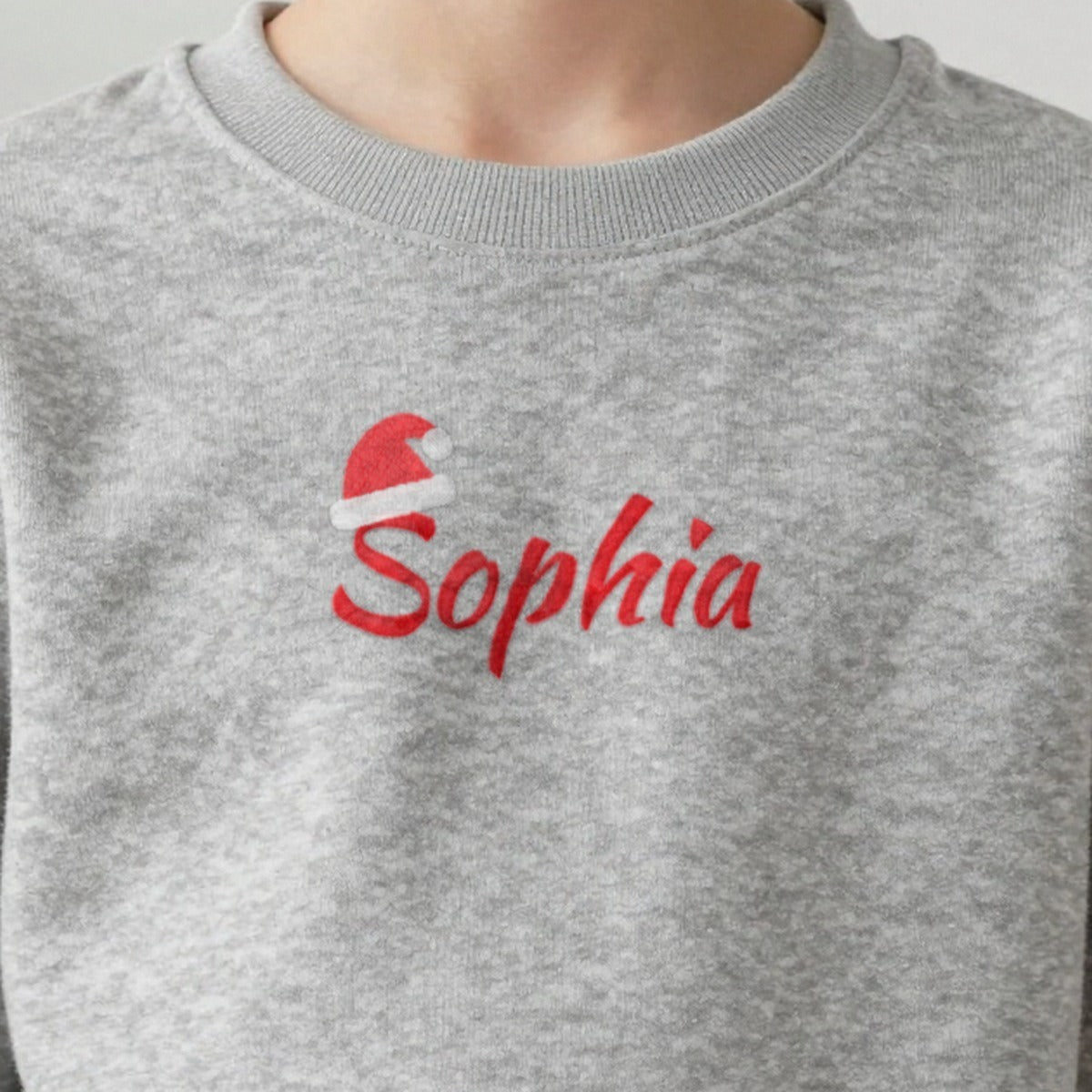 Personalised Embroidered Kids Christmas Jumper with Santa Hat Name, worn