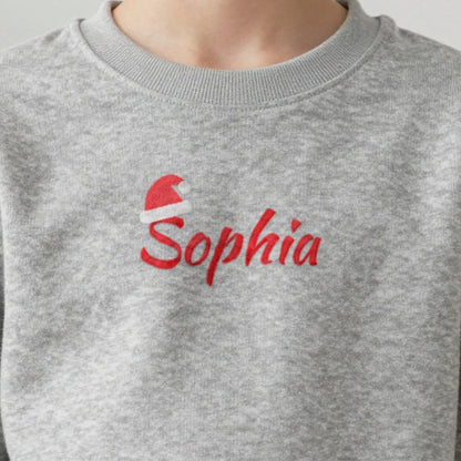 Personalised Embroidered Kids Christmas Jumper with Santa Hat Name, worn
