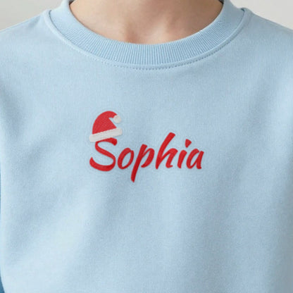 Kids Christmas Jumper with Santa Hat Name, kids sweatshirt in light blue, embroidered