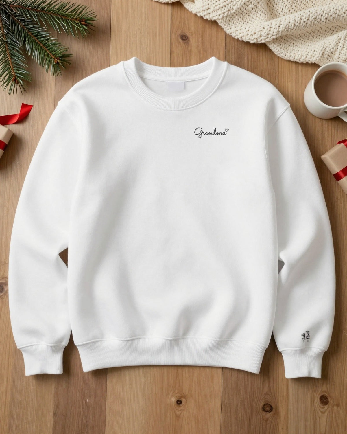 White embroidered Grandma sweatshirt flat lay with names on the sleeve