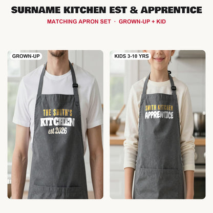 Surname Kitchen Est & Apprentice matching apron set in Dark Grey: grown-up and kids aprons, our photo