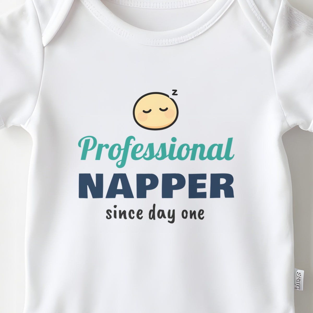 Professional Napper Since Day One baby grow print close-up