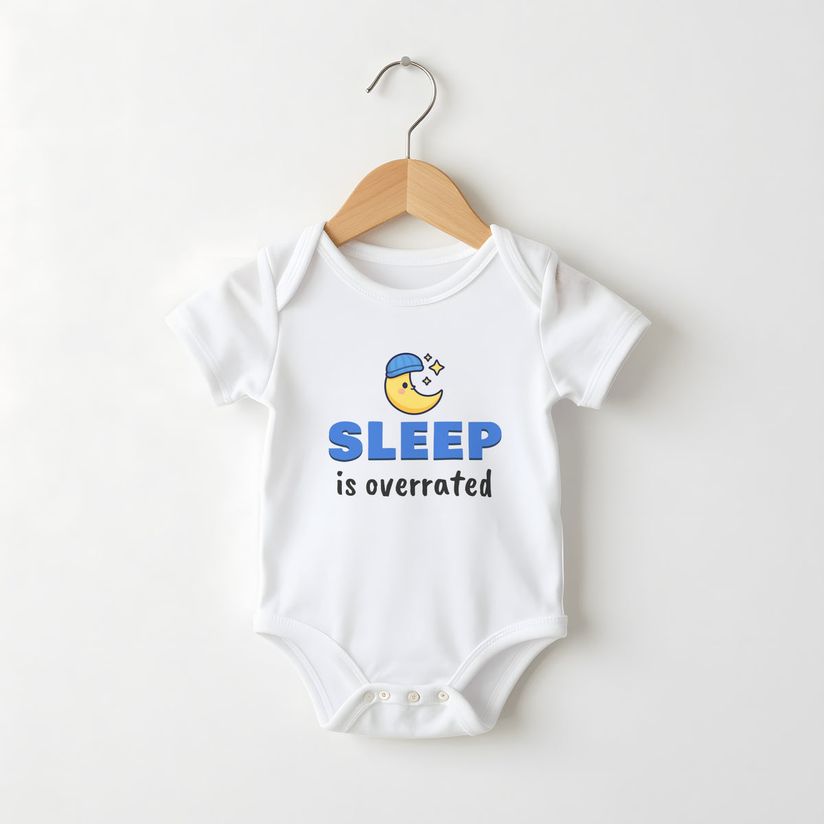 Sleep Is Overrated white baby grow on a hanger