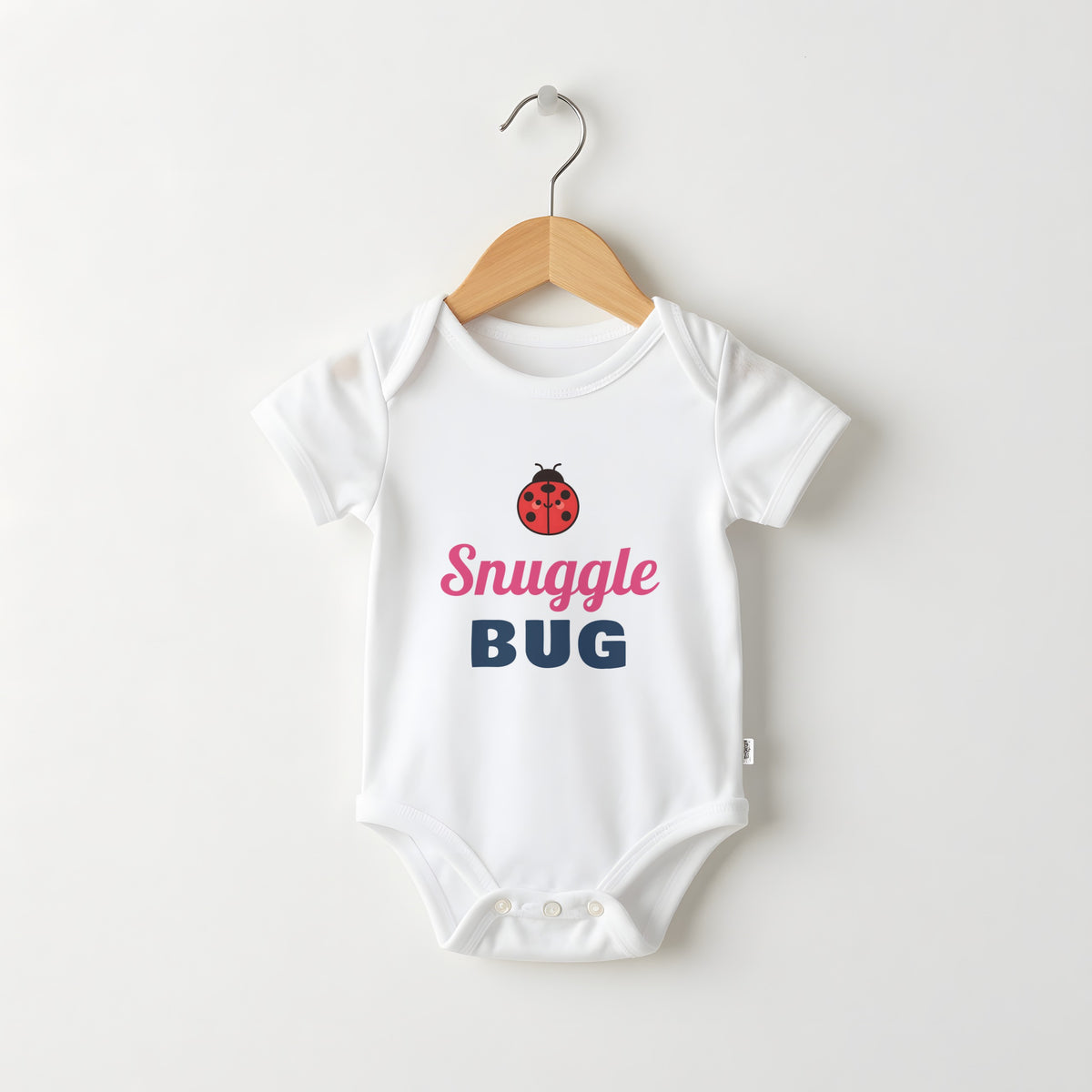 Snuggle Bug white baby grow on a hanger