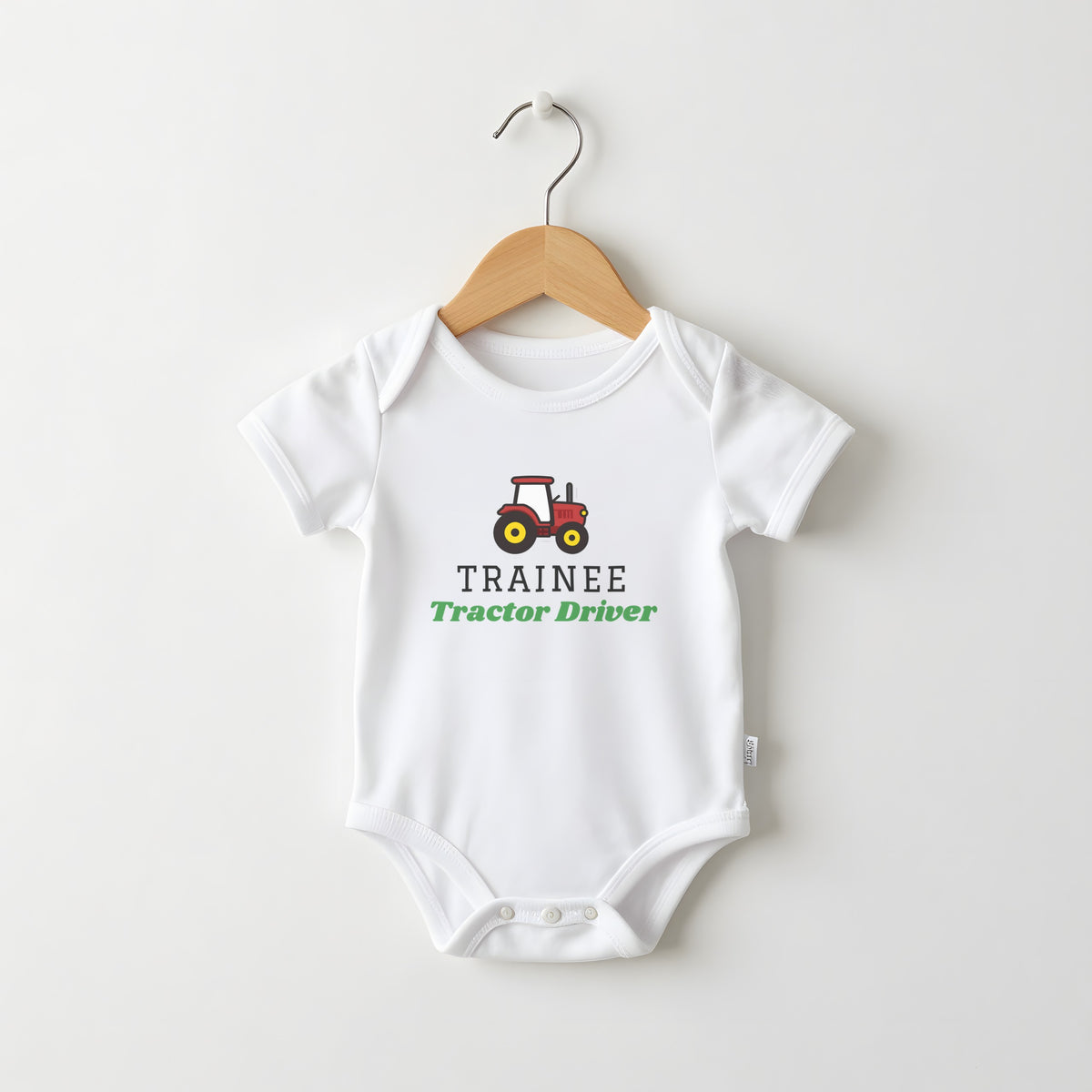 Trainee Tractor Driver white baby grow on a hanger