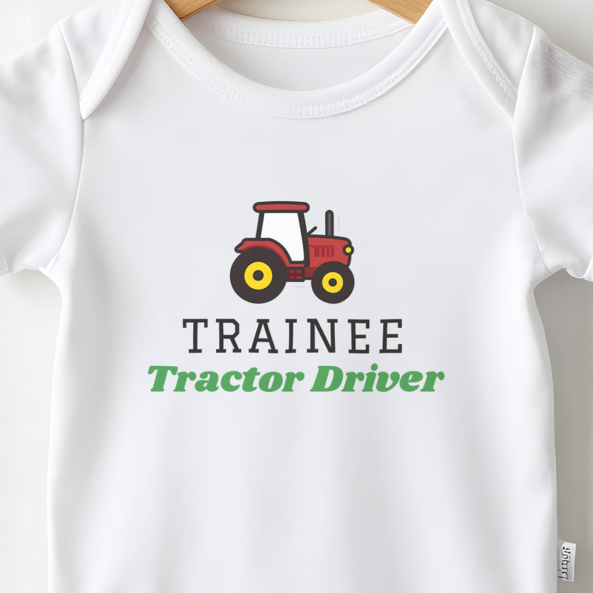 Trainee Tractor Driver baby grow print close-up